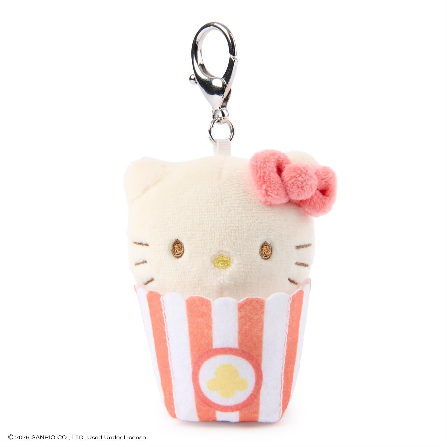 Plush keychain of a cat character with a striped dress on a white background