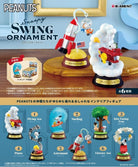 Peanuts Snoopy Swing Ornament set with various figures and decorations on a wooden surface.