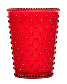 Red glass tumbler with a textured surface on a white background