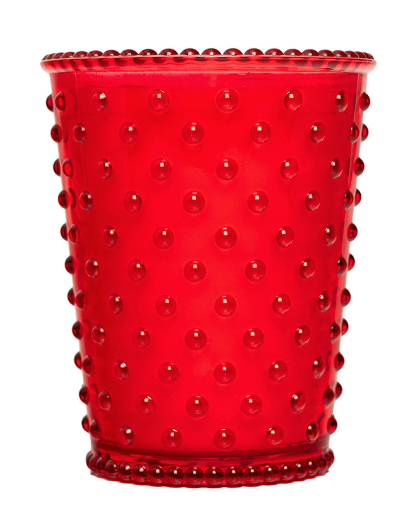 Red glass tumbler with a textured surface on a white background