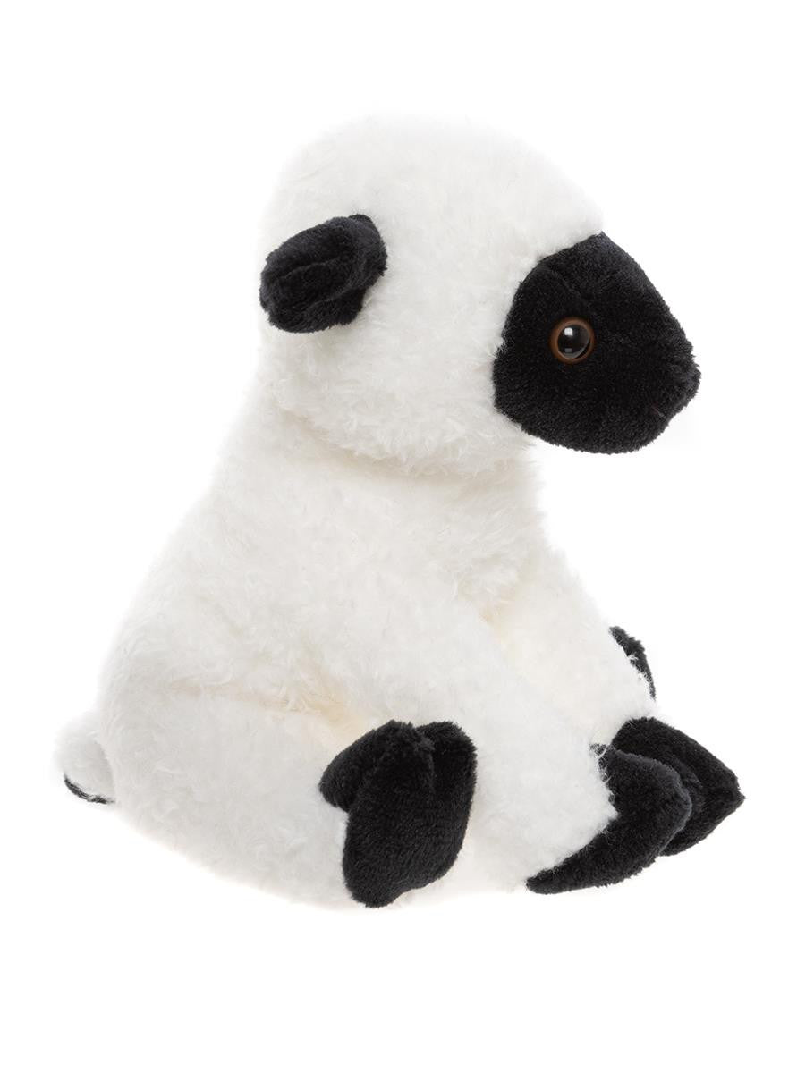 Plush toy of a white animal with black accents on a white background