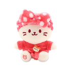 Stuffed pink cat with polka dot bow and a red shirt.