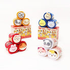 A group of round, plush animal toys and product boxes on a white background.