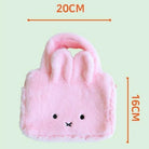 Pink plush bunny bag with measurements on a light green background