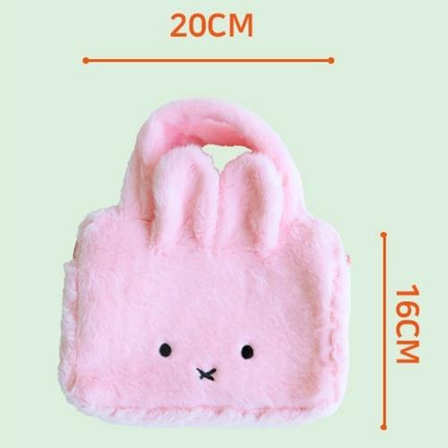Pink plush bunny bag with measurements on a light green background