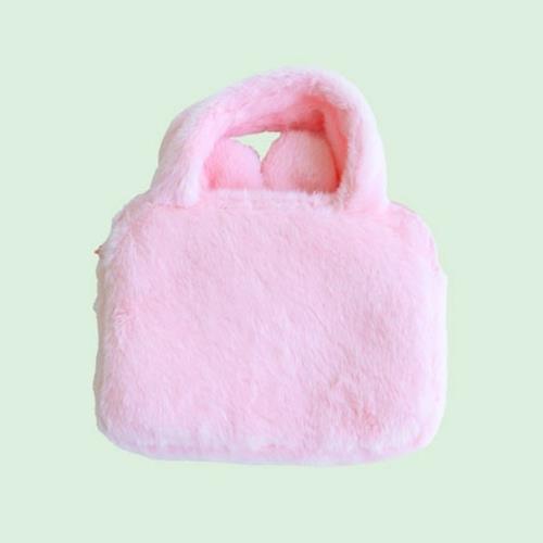 Pink fluffy handbag on a light green background