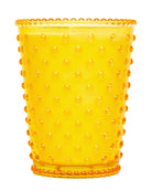 Yellow tumbler with a textured surface on a white background