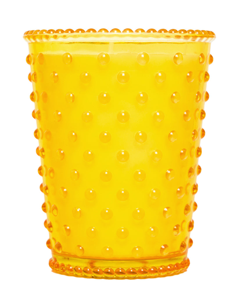 Yellow tumbler with a textured surface on a white background