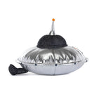 Silver plush flying saucer toy with black glitter dome and orange antenna by Jellycat, side view with textured metallic finish and black tail.