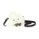 Fluffy white cloud-shaped shoulder bag by Jellycat with black strap, small brown feet, and smiling face, front view.