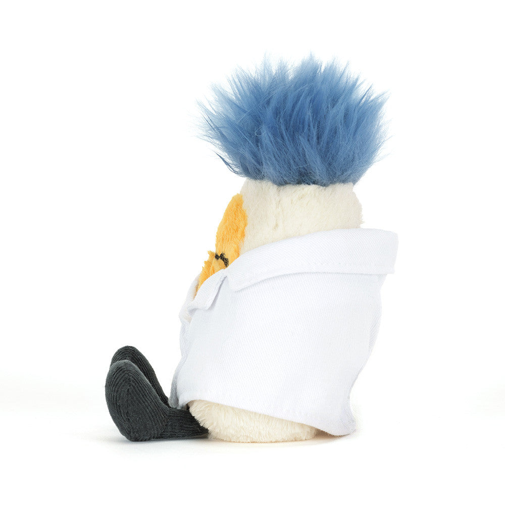 Soft plush boiled egg toy in white lab coat with blue fuzzy hair, by Jellycat, shown from back view with black corduroy shoes.