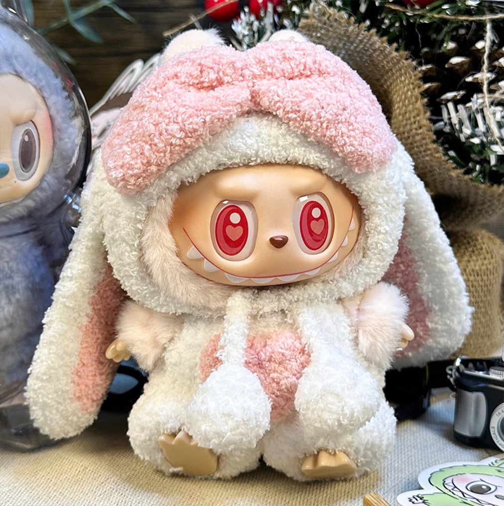 Plush toy wearing bunny costume with pink bow and heart-shaped eyes.
