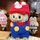Close-up of a plush doll dressed as Mario, with fuzzy red hat, blue overalls with yellow buttons, and large, expressive eyes.