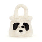 A plush dog-face handbag in cream faux fur with black ears, nose, and eyes, shown on a plain white background.