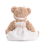 Teddy bear wearing a white dress on a white background