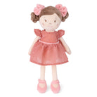Stuffed doll with a pink dress and hair bows on a white background