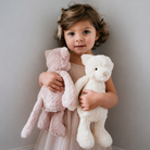Blush plush kitty toy by Snuggle Bunnies, soft textured fur, held by child in lifestyle shot