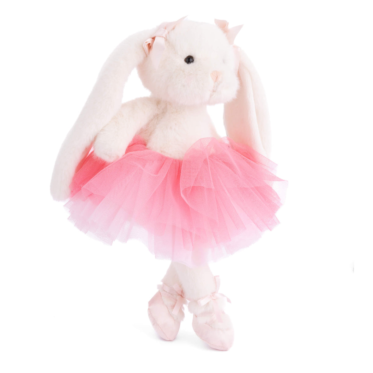 Plush toy rabbit in a pink tutu and ballet shoes on a white background