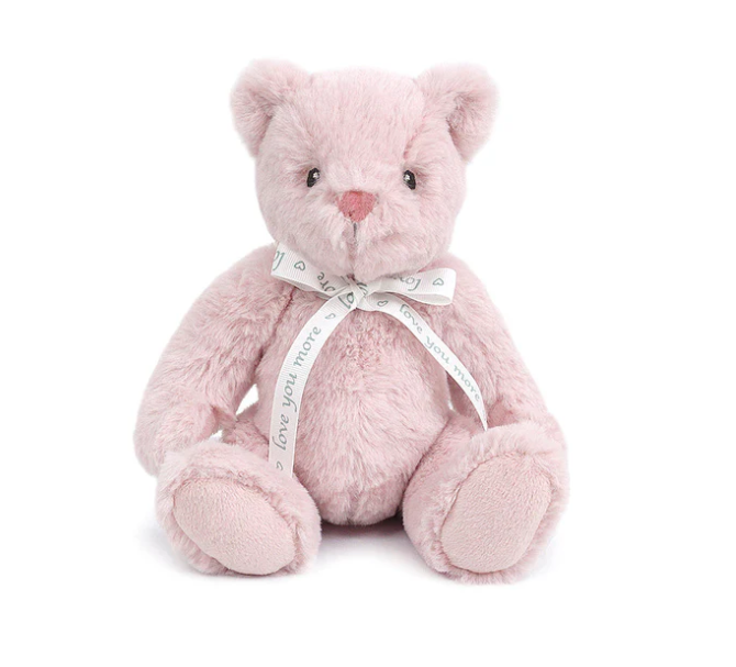 Pink teddy bear with a bow on a white background