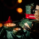 Candles and decorative items on a dark background with blurred lights