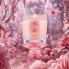 Pink candle with decorative label surrounded by pink flowers and butterflies