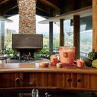 Outdoor setting with a stone fireplace, wooden counter, and decorative items.