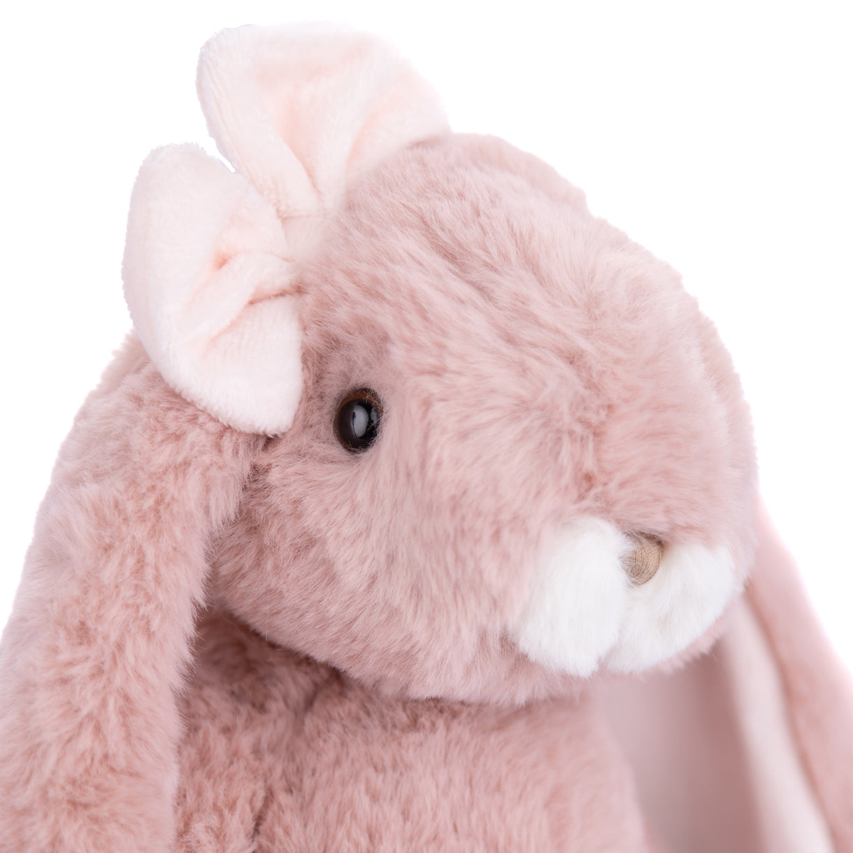 Close-up of a pink plush bunny with a white flower on a white background