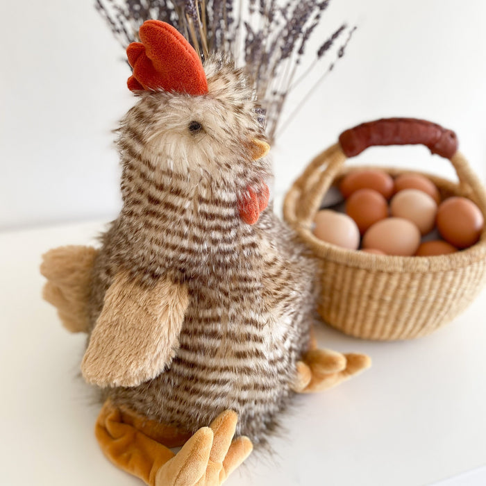Stuffed chicken beside a basket of eggs.
