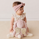 Pink glitter plush bunny with gold sequin wings by Snuggle Bunnies, shown from back view with baby wearing floral dress and pink headband.
