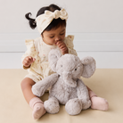 Soft gray plush elephant toy by Snuggle Bunnies, 12 inches, with textured fur, sitting on lap of child in floral outfit, lifestyle view