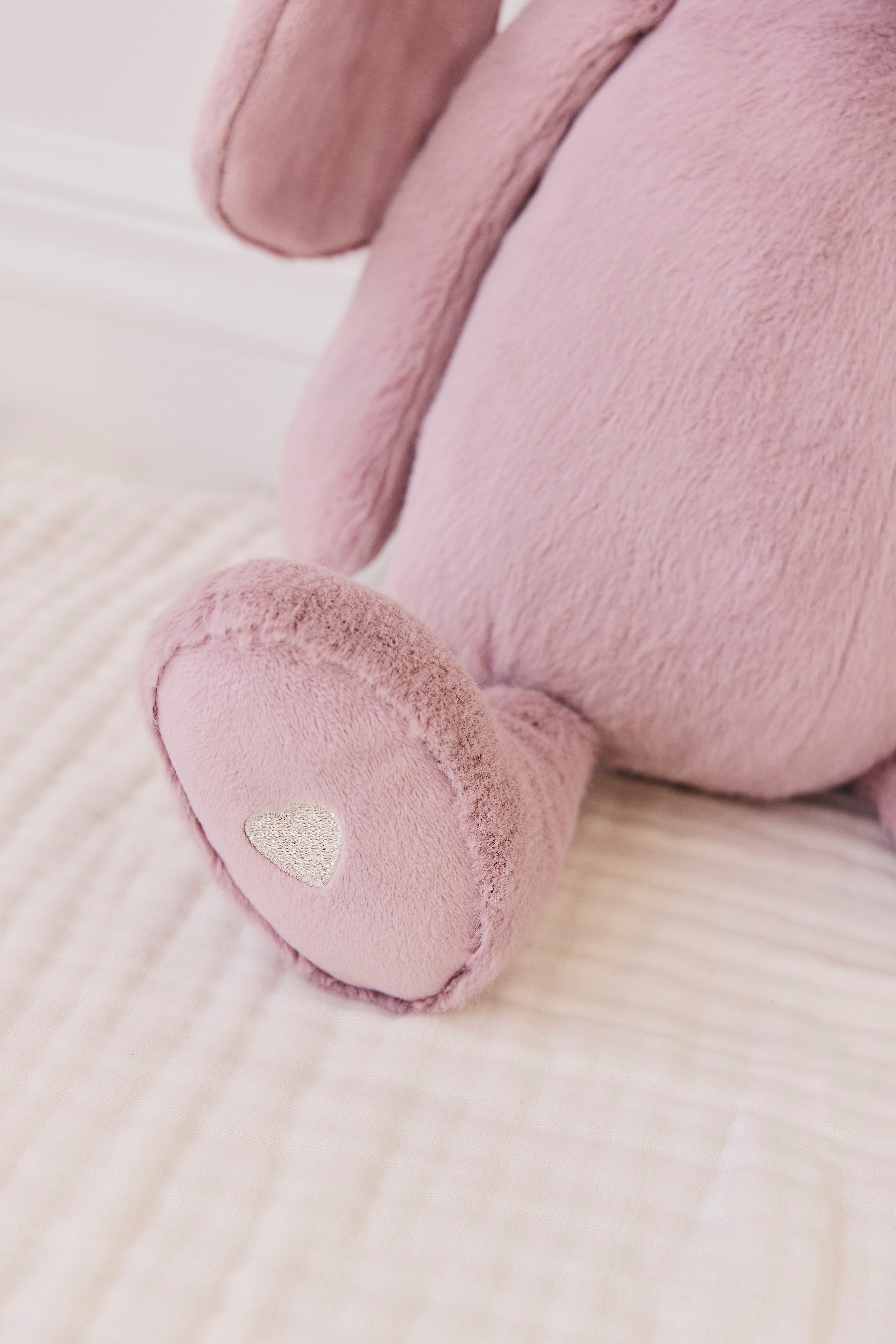 Close-up of a pink plush toy on a light surface