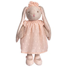Stuffed bunny toy with a pink dress on a white background
