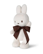 White plush bunny with a brown bow.
