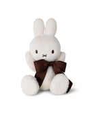 Creamy white stuffed rabbit with a brown ribbon bow.