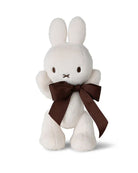 White bunny plush toy with brown bow.
