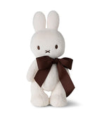 White bunny plush toy with a brown bow.
