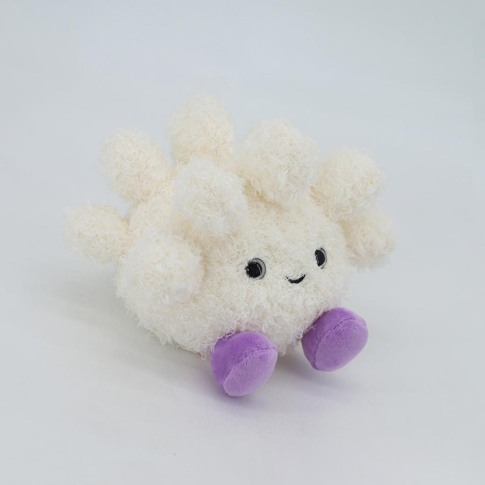 Plush toy with a white body and purple paws on a light gray background