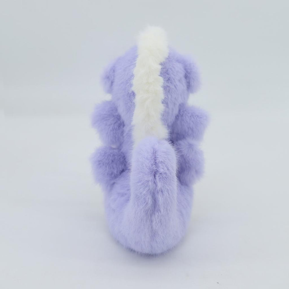Plush toy dragon with purple body and white accents on a light gray background