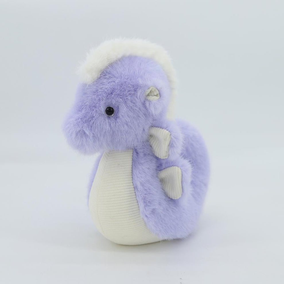 Plush toy dragon with purple body and white accents on a light gray background