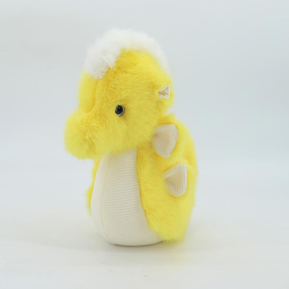 Yellow plush toy with white accents on a light gray background