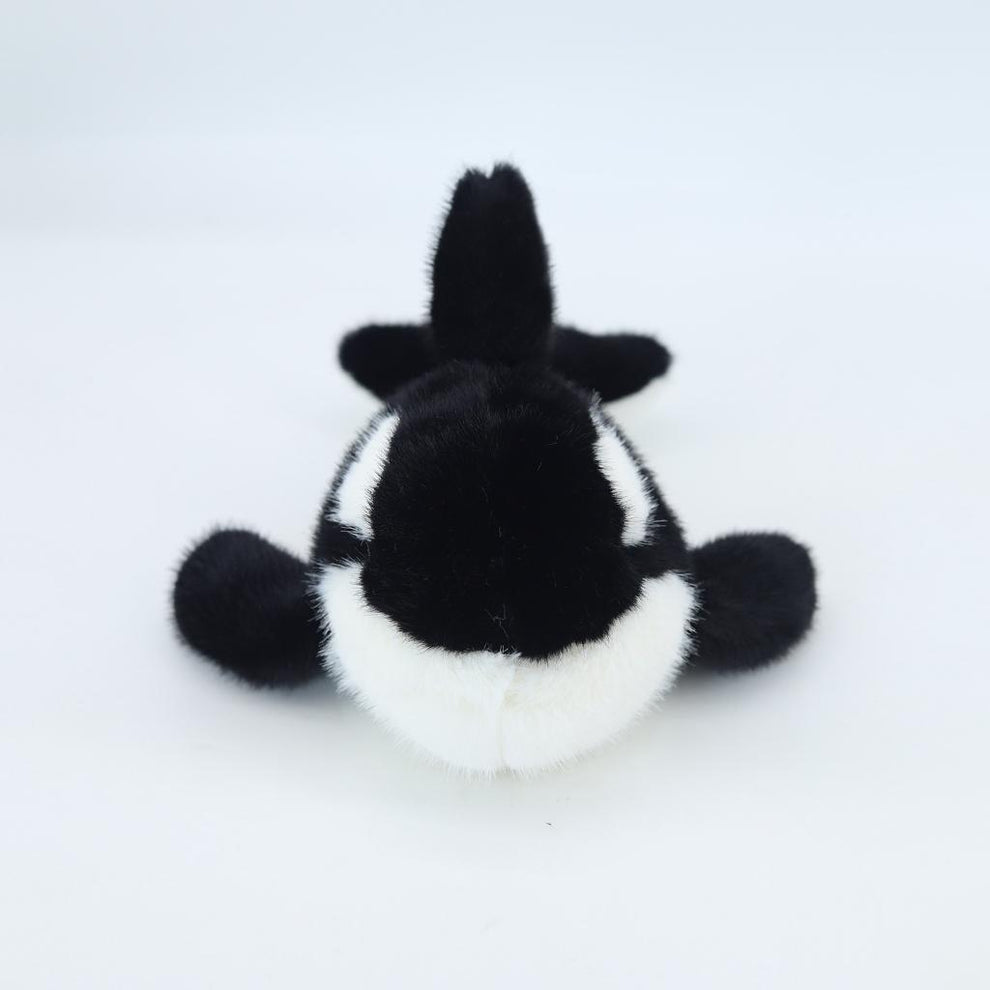Black and white plush toy on a light gray background