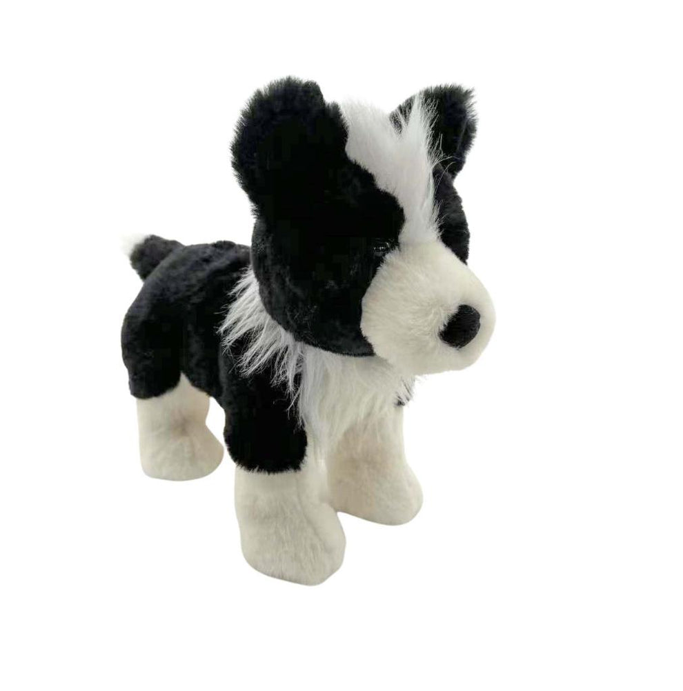 Black and white stuffed dog toy on a white background