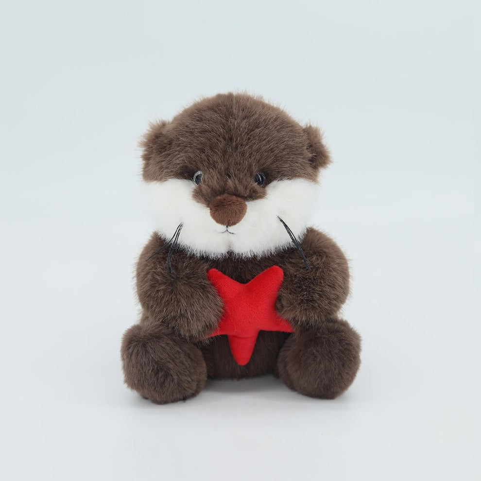 Brown sea otter with a red star on a white background