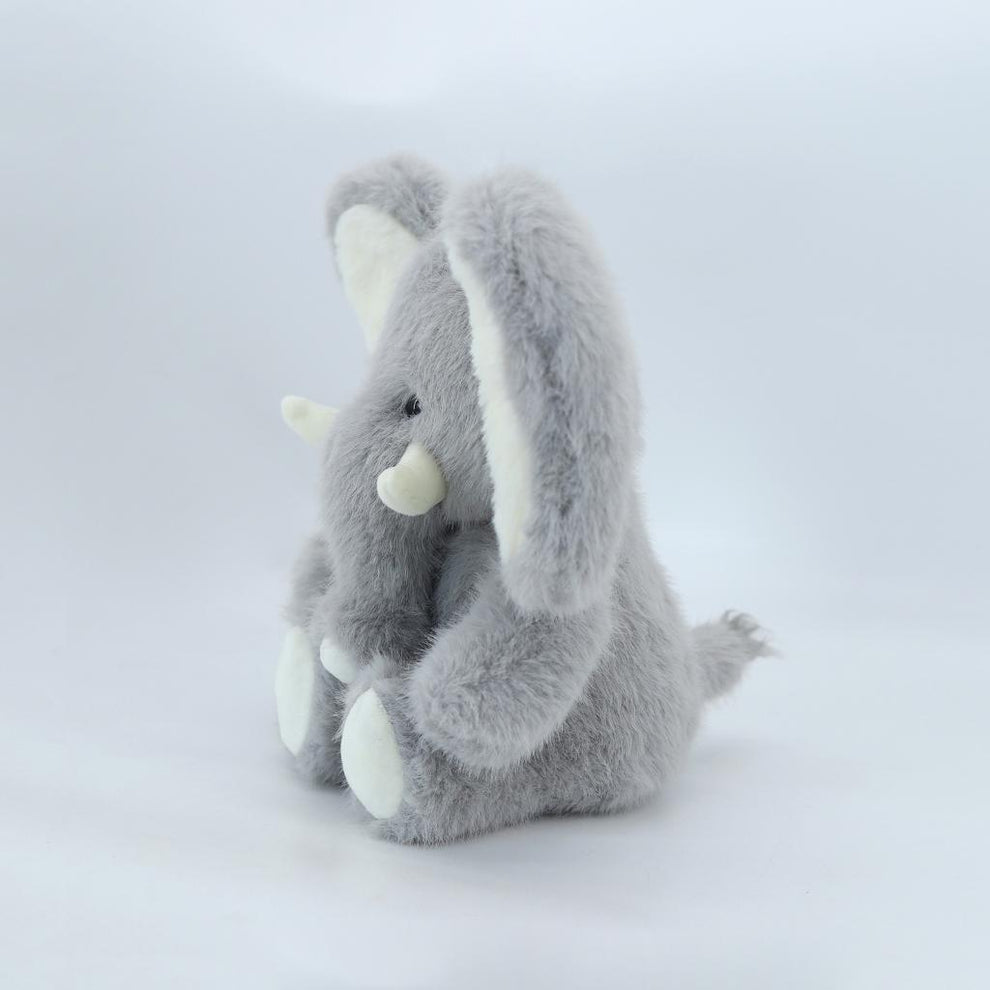 Plush toy resembling a triceratops on a white background