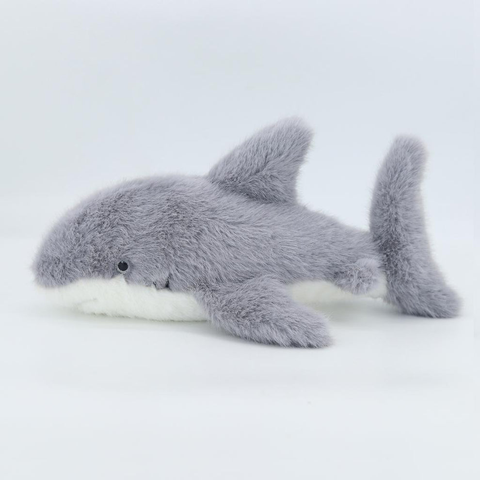 Plush shark toy on a light gray background