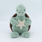 Plush turtle toy with a star on a white background