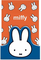 A Miffy-themed card or sticker featuring a large white rabbit head silhouette on a blue shape at the bottom, with an orange background patterned with smaller white rabbit faces and the word 'miffy' in white text.