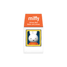 A Miffy branded stress ball in its retail packaging, featuring a white ball with rabbit ears and a black mouth, framed in yellow and blue, with an orange top label reading 'miffy Stress Ball'.