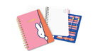 Pink notebook with a cartoon character on the cover and a blue planner on a white background
