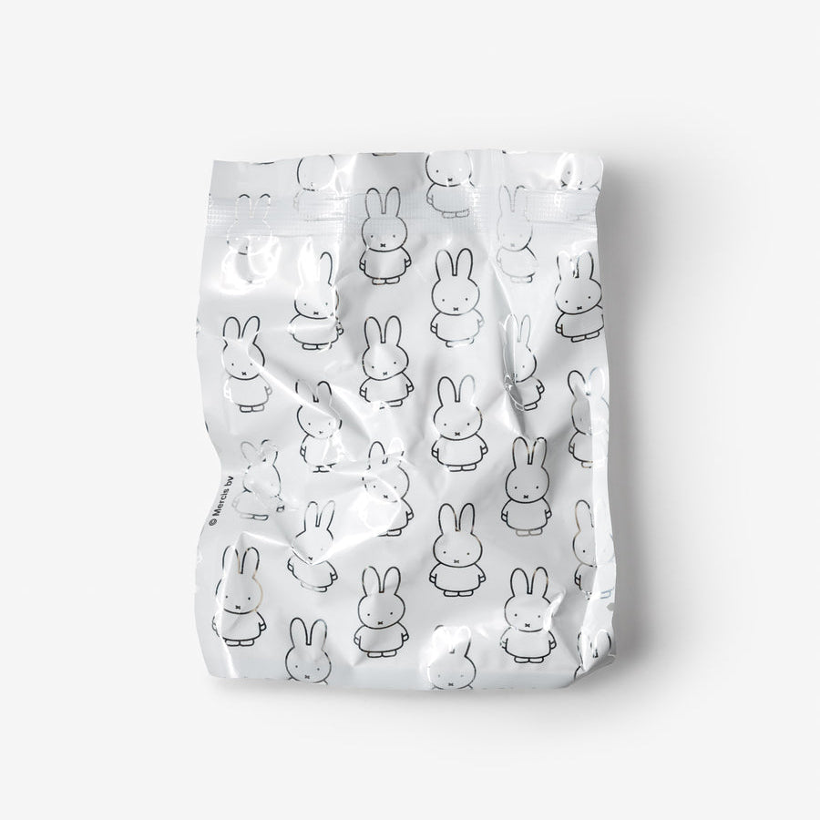 A crinkled silver metallic pouch featuring an all-over black line-art pattern of cartoon rabbits, shown against a plain light gray background.